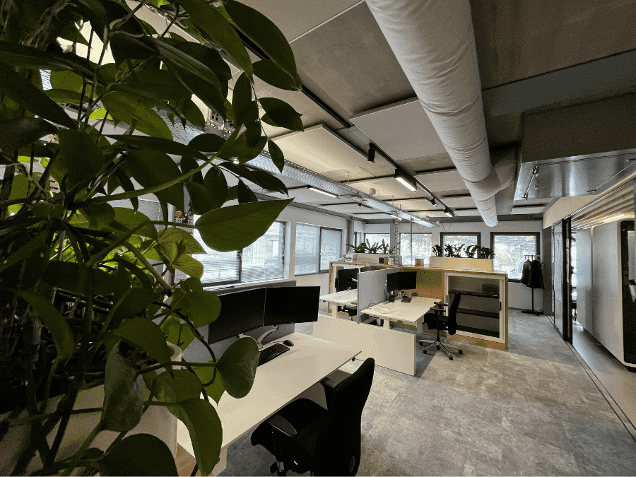 Kantoortuin van Nijhuis Bouw met gemonteerde EASYceiling Plus plafondpanelen onder een betonnen plafond.