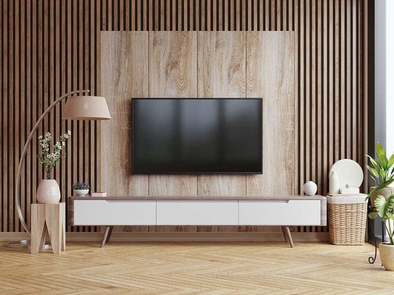 EASYwood Akupanel in Dark Oak schafft eine stilvolle TV-Wand mit verbessertem Klangkomfort. Die dunklen Holzlamellen reduzieren störenden Nachhall und sorgen für eine angenehme Akustik beim Fernsehen. Eine elegante und funktionale Lösung für moderne Wohnräume.